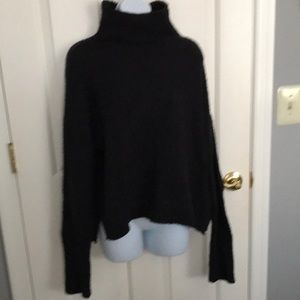 Ugg sweater in solid black. Nubby yarn. Ply and nylon. Cold water wash.